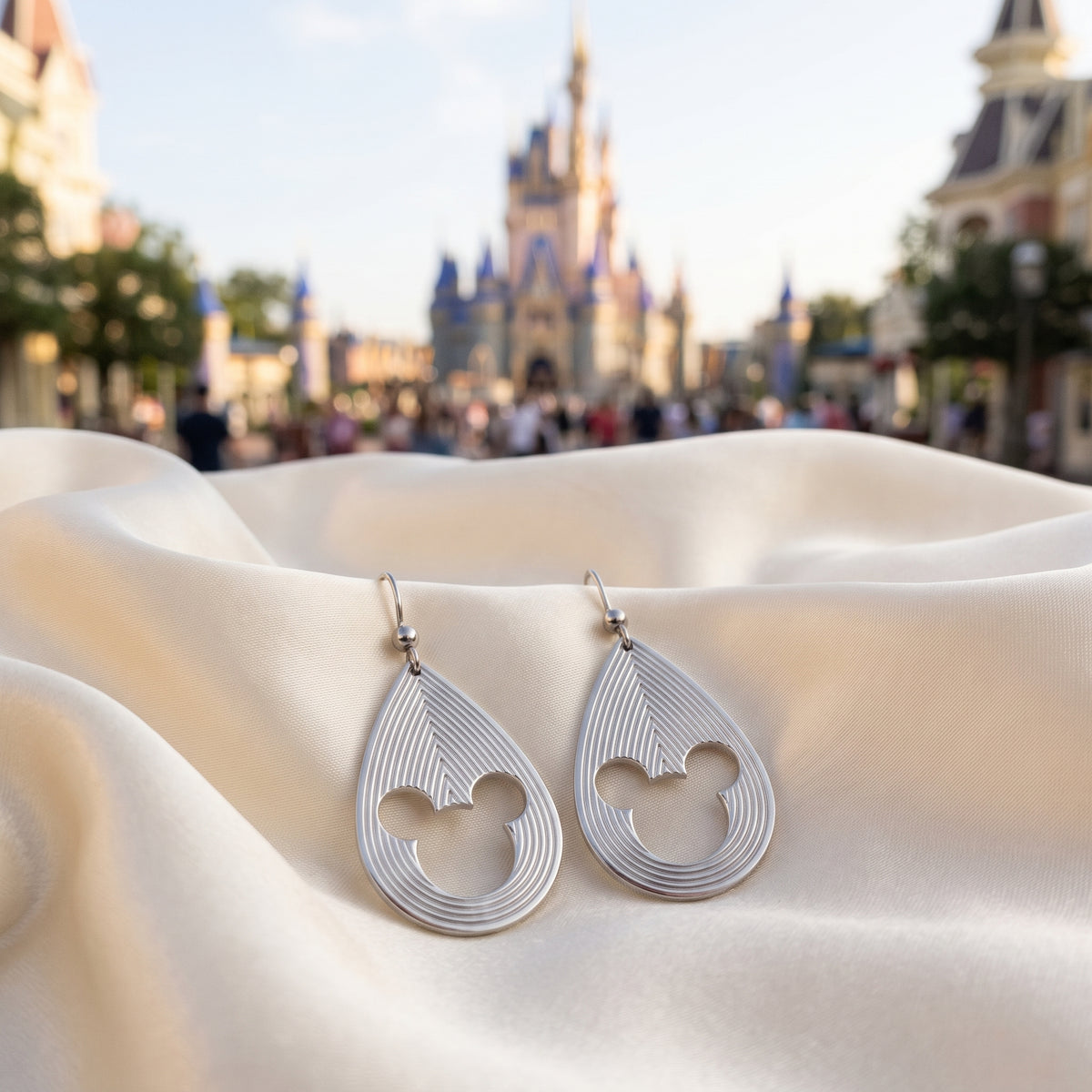 Mickey Mouse earrings with layered teardrop lines and 3D style.